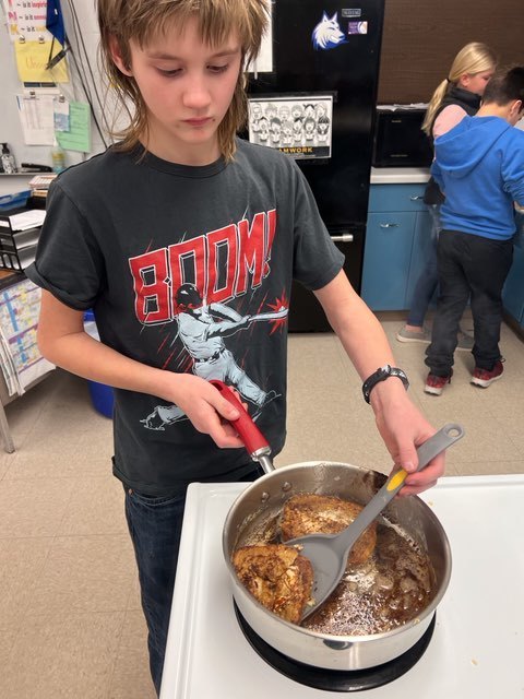 A student getting ready to flip the French Toast!!