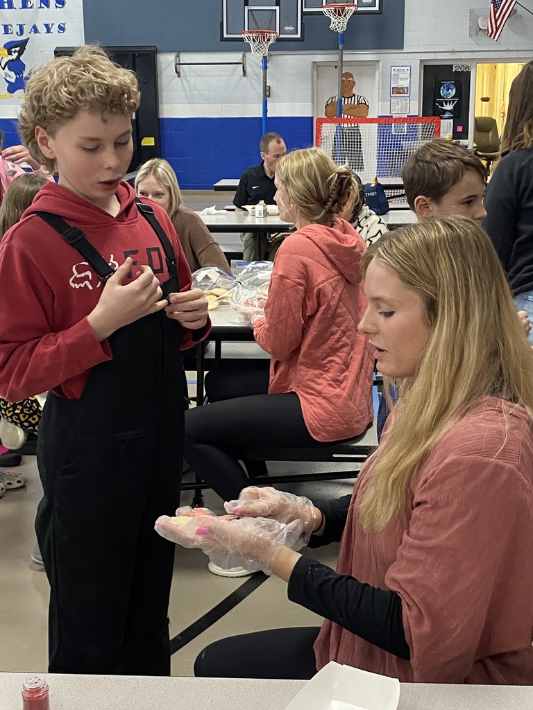 FCCLA club president frosts a cookie for a patient customer.  