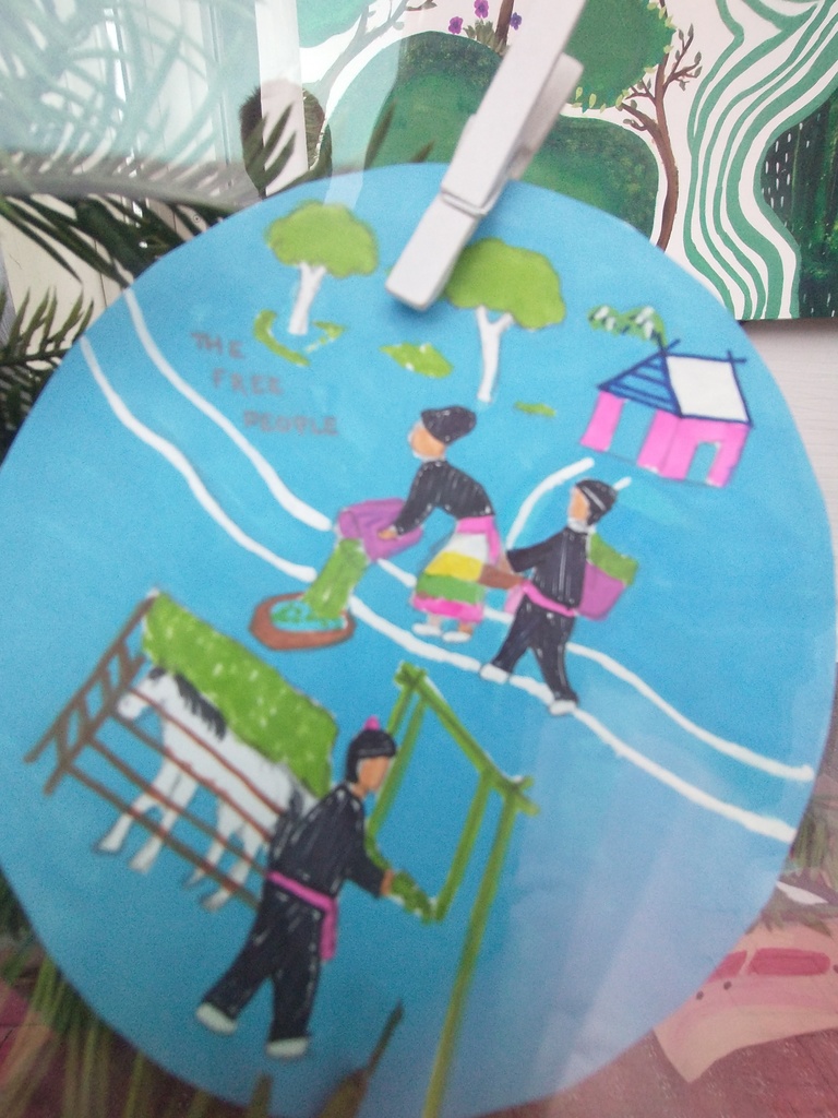 Circle piece depicting Hmong storytelling artwork