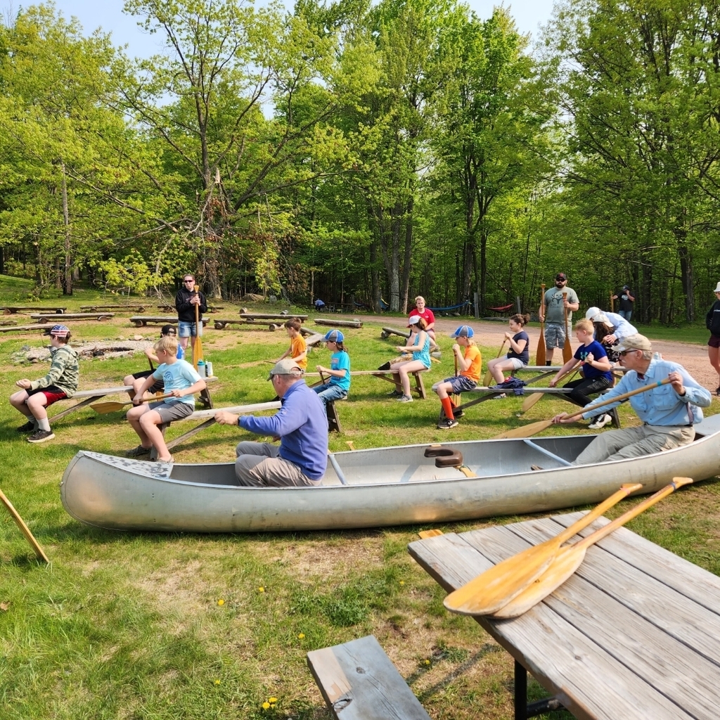 Students practice their paddling on dry land.