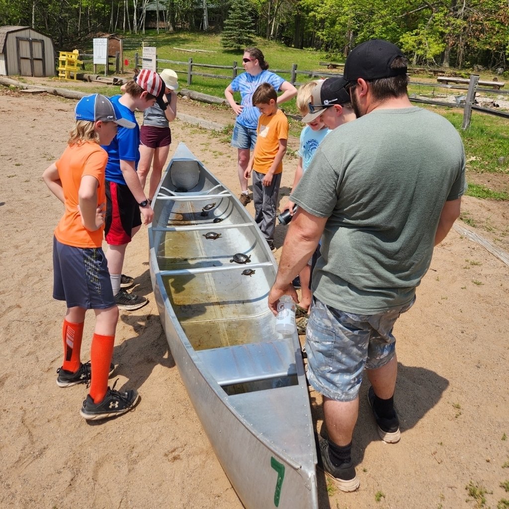 Students and chaperones take a look at the collection of turtles caught out on the lake.